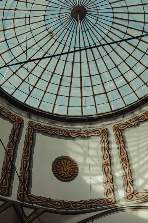 Free Intricate ornate glass dome ceiling viewed from below, showcasing elegant architectural design. Stock Photo
