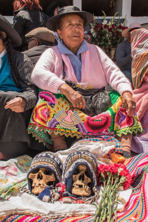 Free Elderly woman in Chongos Bajo market with vibrant textiles and skulls, Junín, Peru. Stock Photo