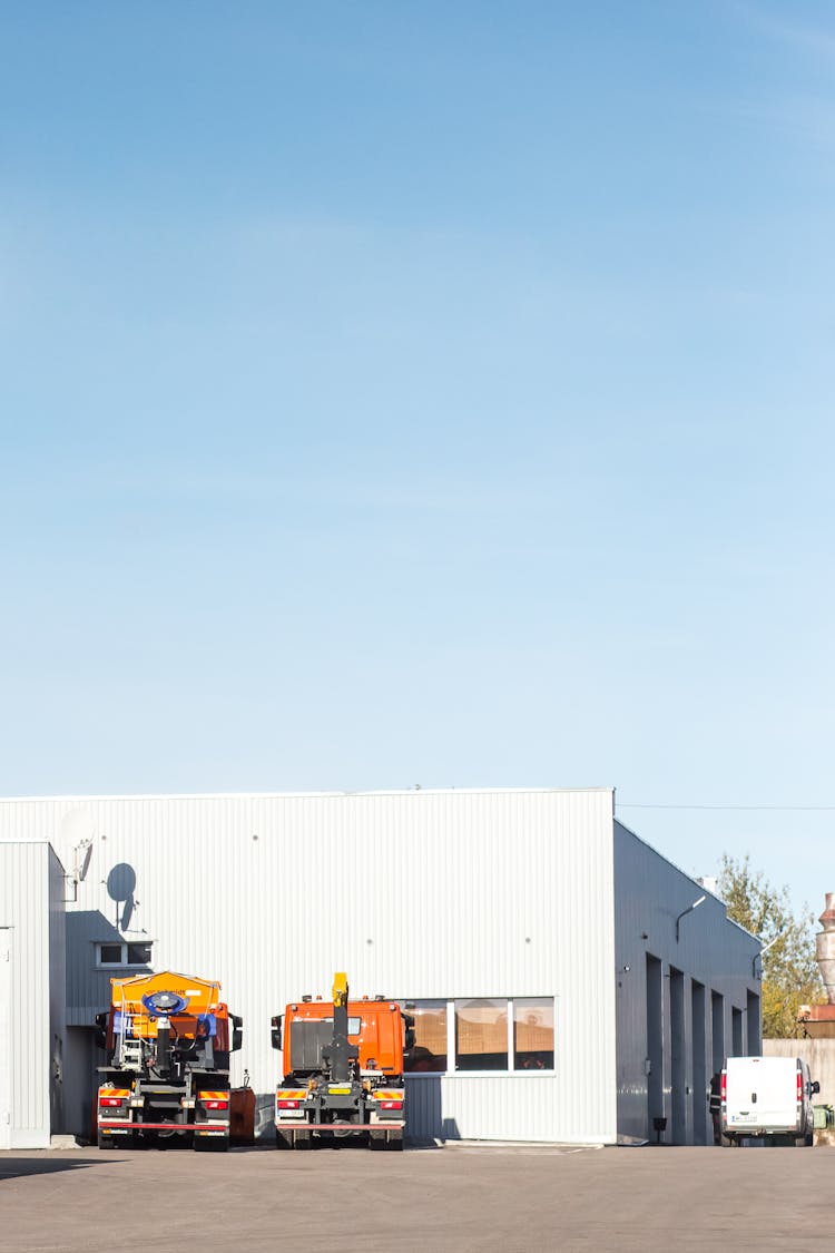 Warehouse And Trucks Under Blue Sky