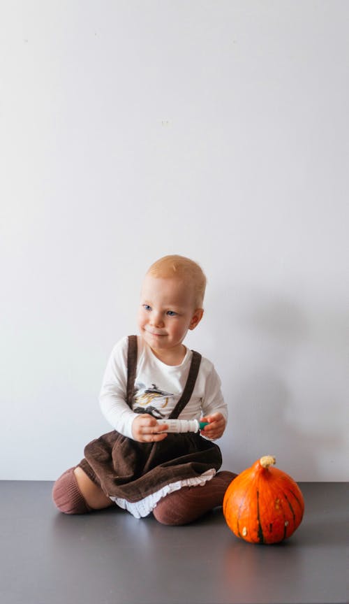 A Child Sitting on the Floor