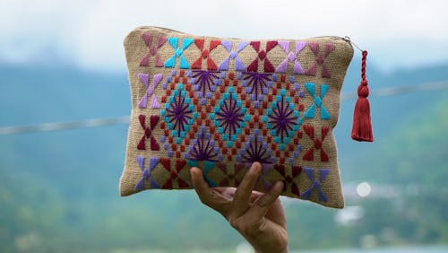 Person Holding a Colorful Pouch
