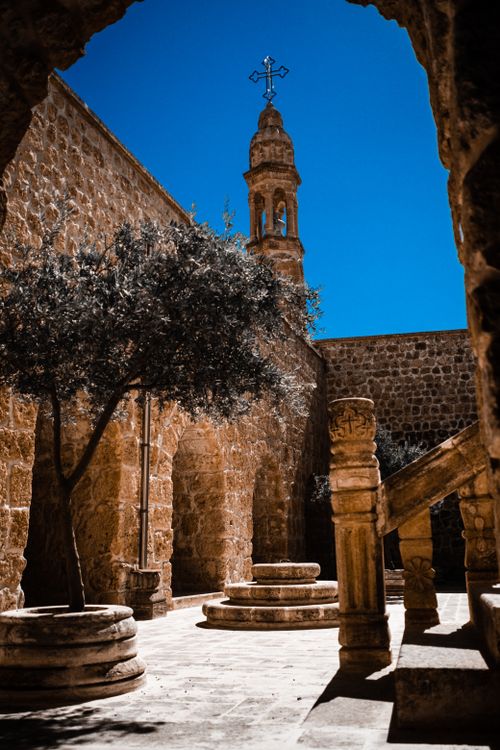 Free Explore the serene courtyard of Mor Gabriel Monastery in Mardin, Türkiye with stunning architecture. Stock Photo