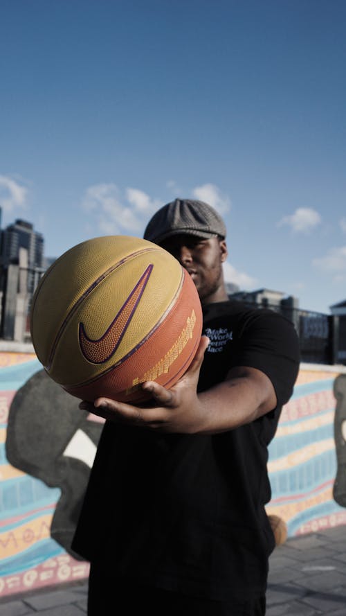 A Man in Black Shirt Holding a Basketball