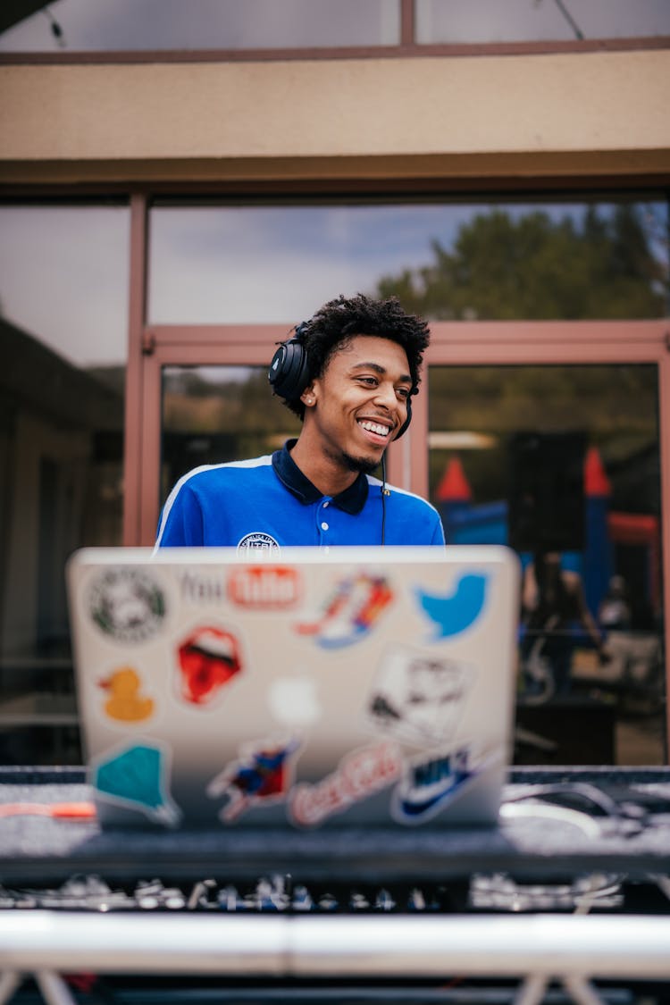 Smiling Man With Laptop And Headphones