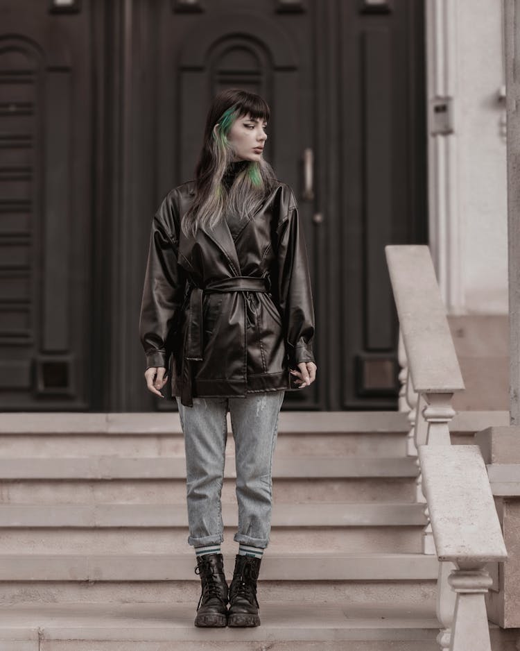 Young Woman In Leather Jacket And Jeans