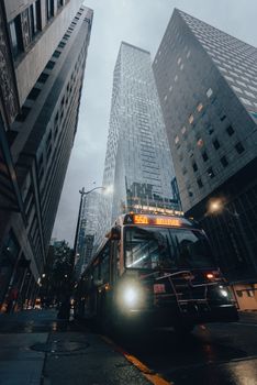 Moody shot of a city bus and skyscrapers in downtown Seattle on a gloomy day.
