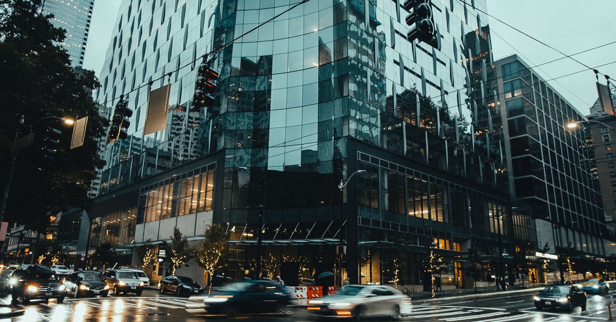 Cars on Road Near High Rise Buildings · Free Stock Photo