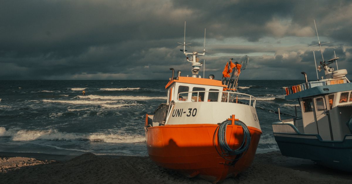 a small boat anchored in rough ocean waves, sky clearing in the distance