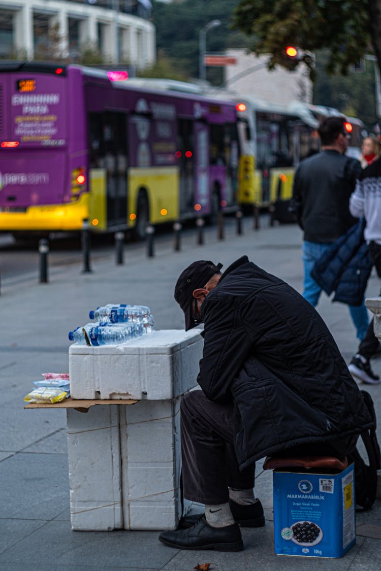 Man Selling Bottled Water On Street