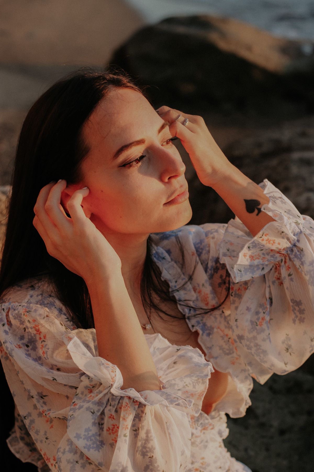 A close-up of a woman in a delicate floral dress — the small, refined print