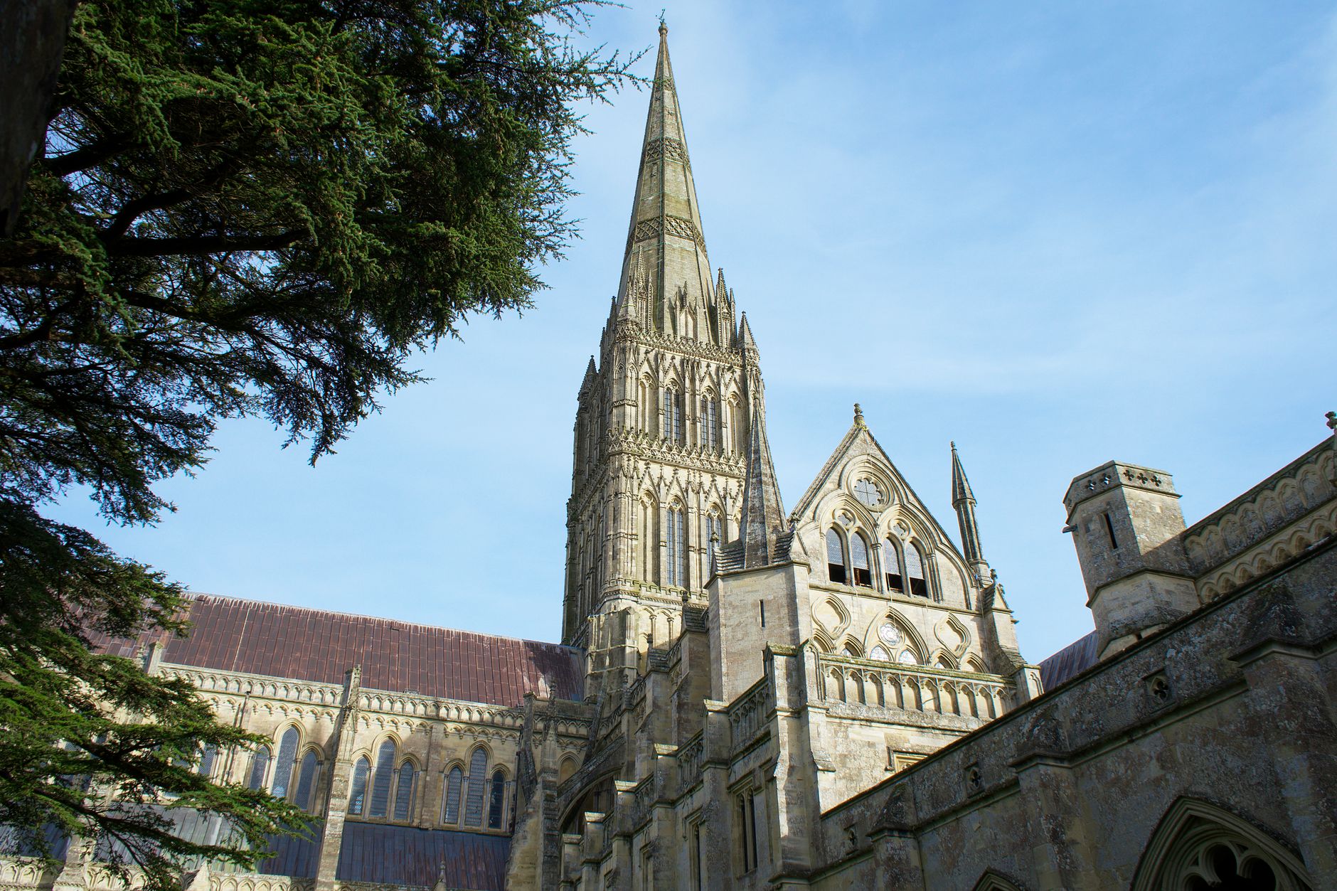 Salisbury Cathedral's stunning Gothic facade with a blue sky backdrop in England.