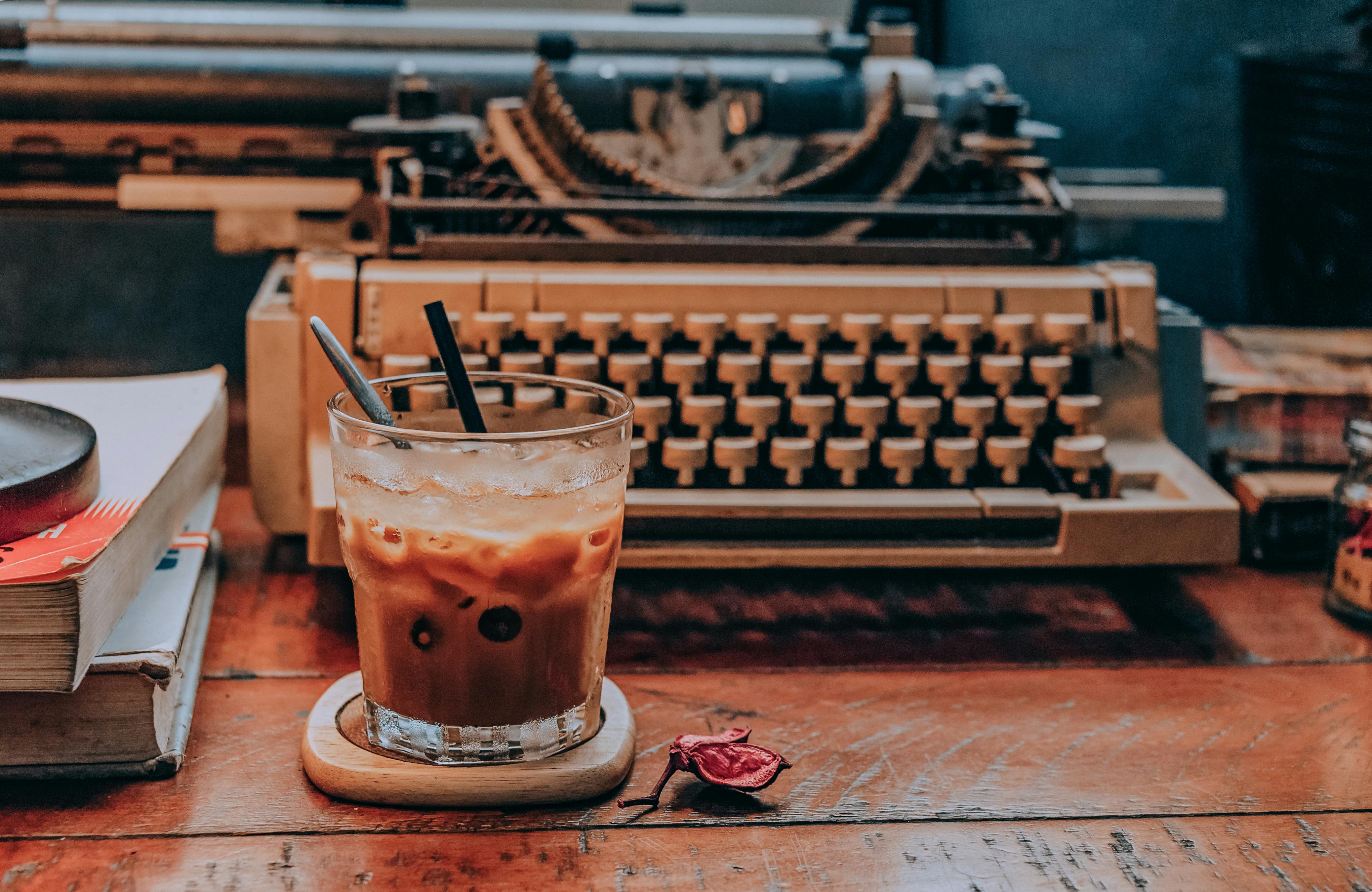 iced coffee in front of typewriter