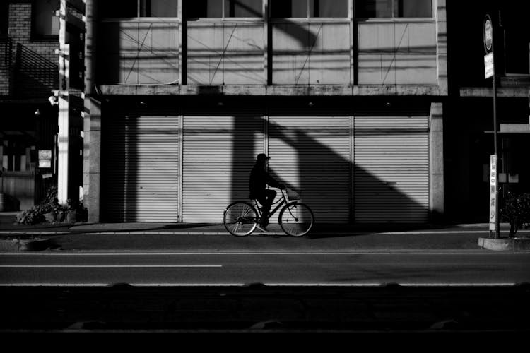 Man Riding Bike On City Street