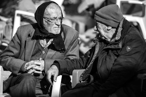 Grayscale Photo of Two Elderly Men