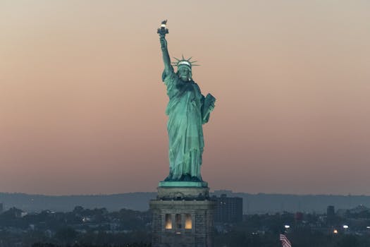 Iconic Statue of Liberty against a beautiful dusk sky in New York City.