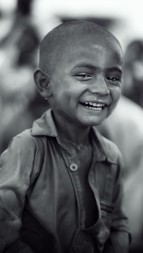 Free Black and white portrait of a happy child smiling with innocence and joy. Stock Photo