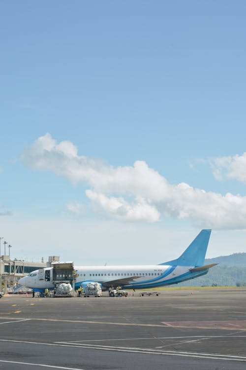 White and Blue Airplane on the Airport 