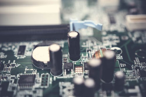 Free Selective Focus Photo of Electrolytic Capacitors on Circuit Board Stock Photo