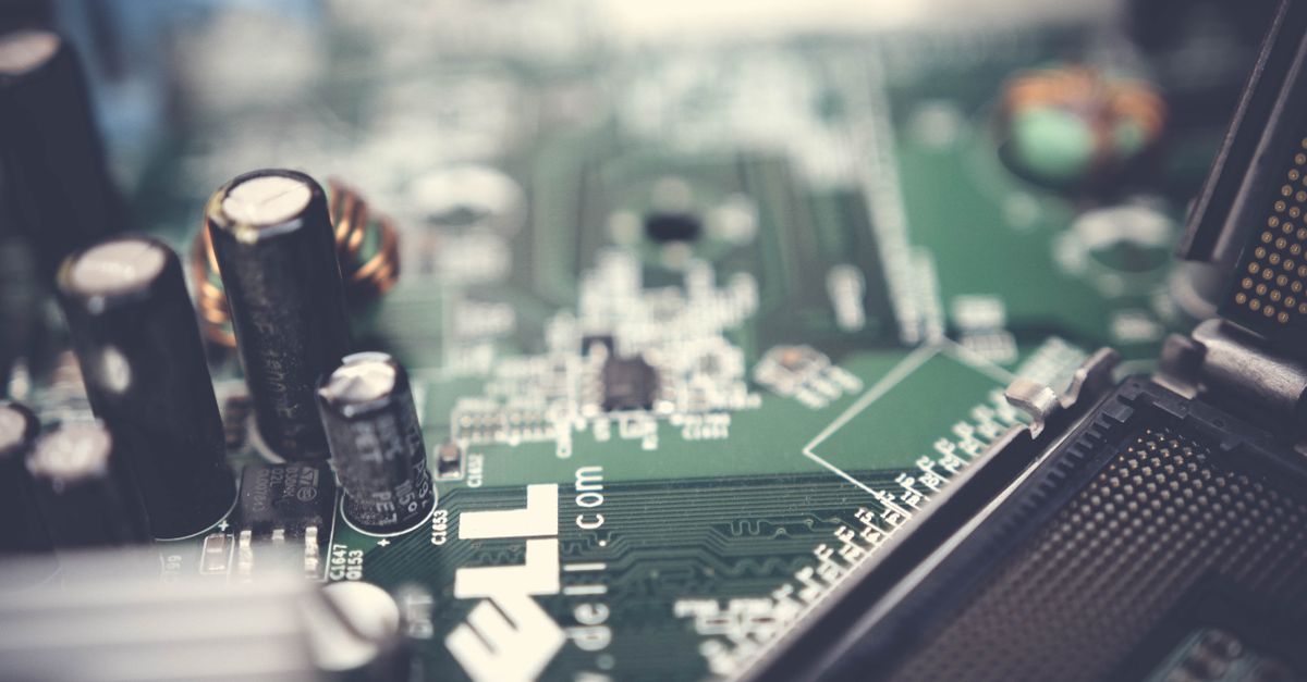 Detailed view of a computer motherboard highlighting capacitors and connections.