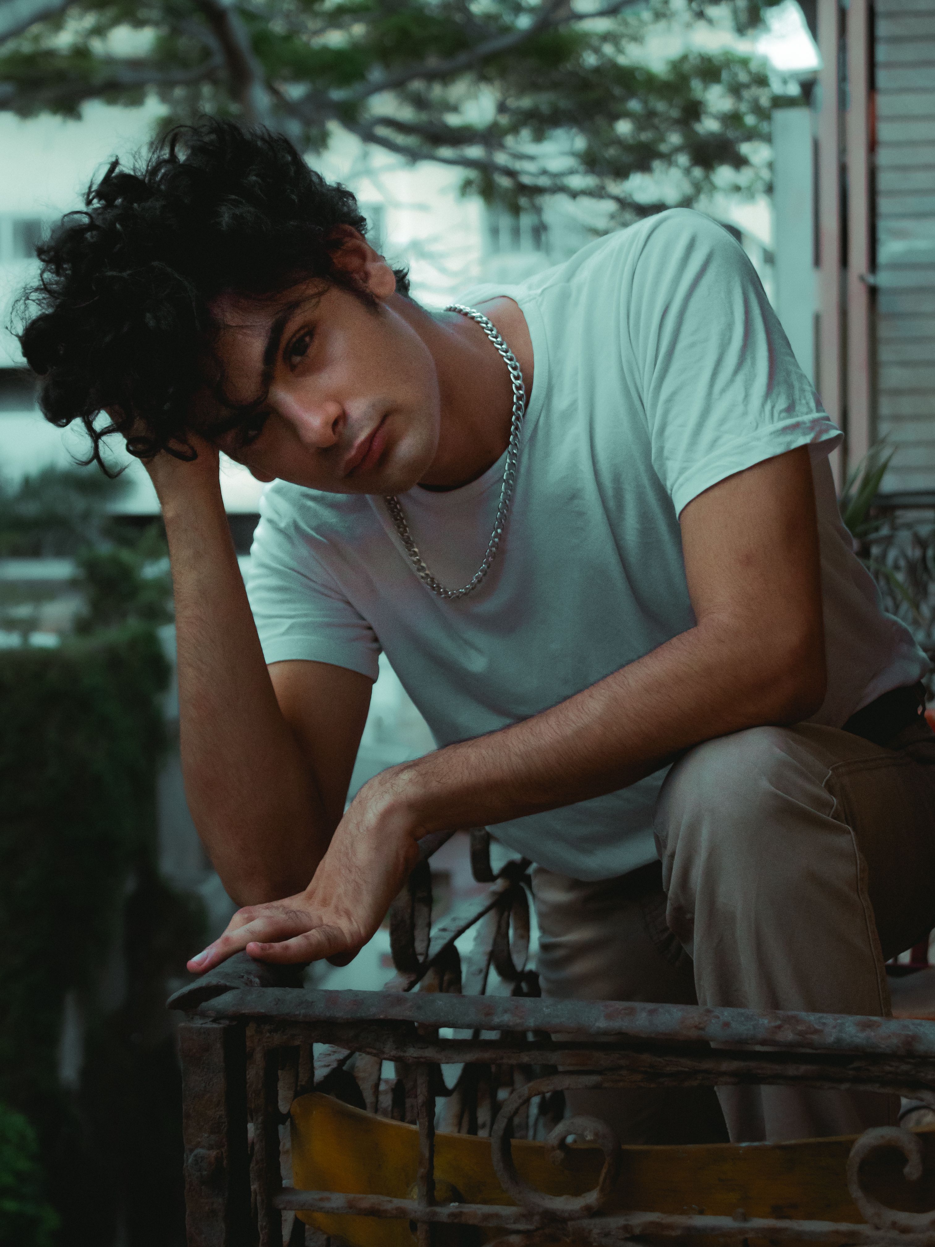 A thoughtful portrait of a man leaning on a railing in Alexandria, Egypt.