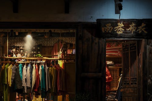 Wooden Sign above the Entrance of a Clothing Store