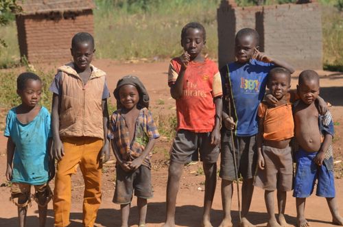 Free Six young boys standing together outdoors, displaying friendship and playfulness. Stock Photo