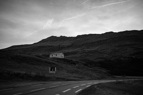 Grayscale Photo of a Mountain Road