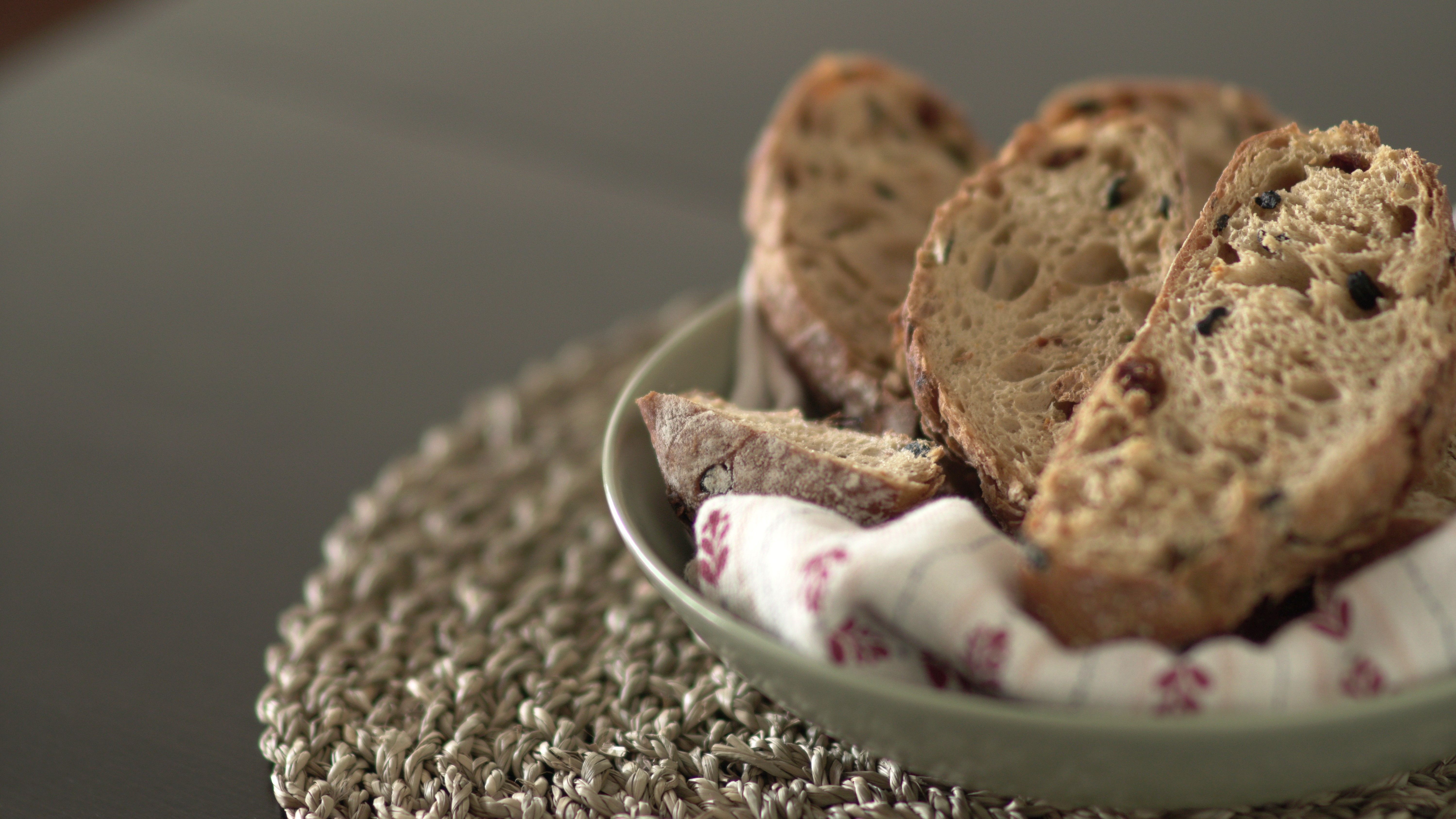 Close-up of rustic artisan bread slices in a bowl, perfect for culinary presentations.