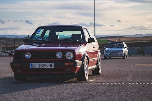 A classic Volkswagen car parked in a sunny lot in Alcañiz, Spain, showcasing a vintage vibe.