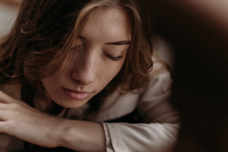 Portrait Of Pensive Woman With Eyes Closed