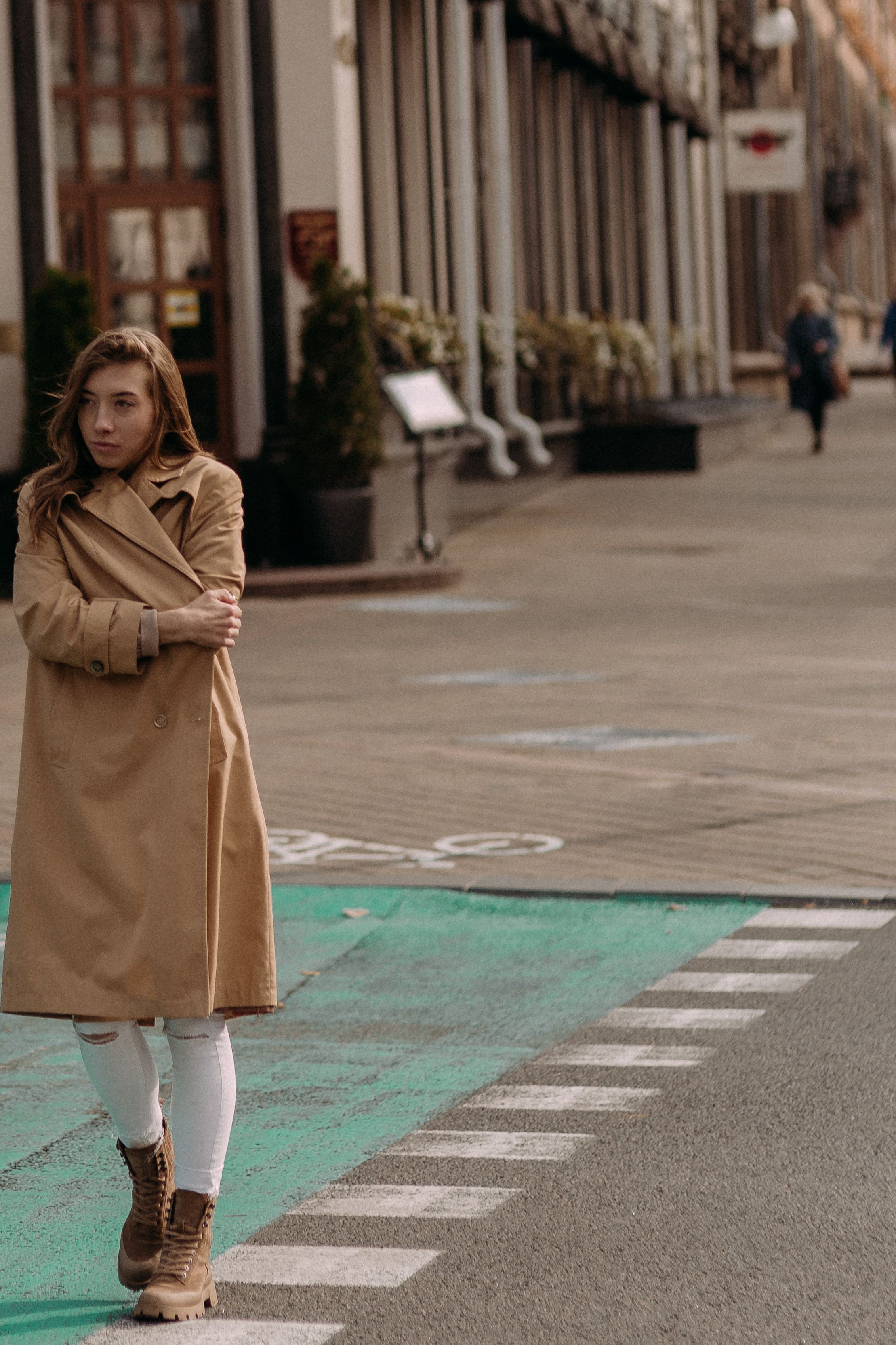 A Woman in Brown Coat Standing on Sidewalk · Free Stock Photo