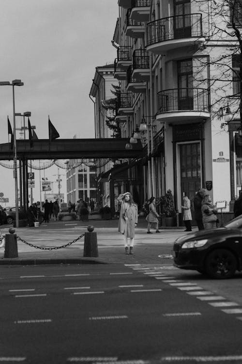 Free Grayscale Photo of a Woman Standing Near on Pedestrian Lane Stock Photo
