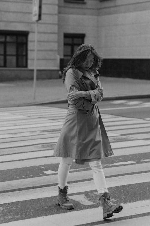 Free A Woman in a Coat Crossing the Street Stock Photo