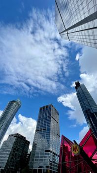 Experience the striking architecture of Warsaw with towering skyscrapers under a vibrant blue sky.