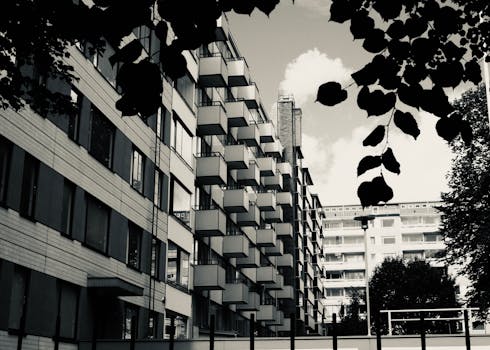 Contemporary residential buildings with distinct geometric balconies in an urban setting.