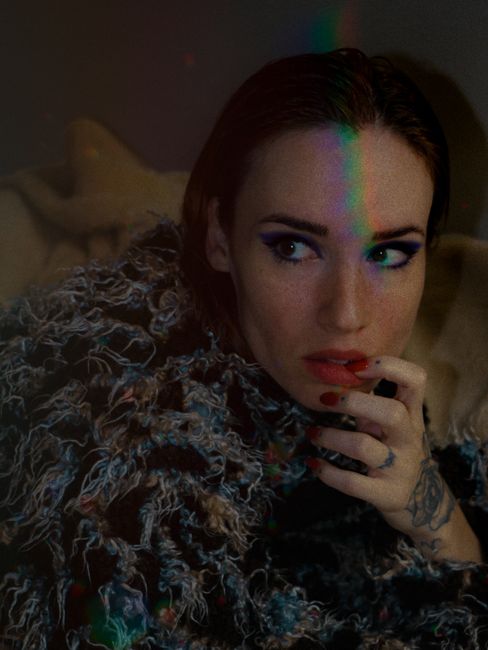 Elegant woman in textured winter clothes, captured in a moody and artistic portrait.