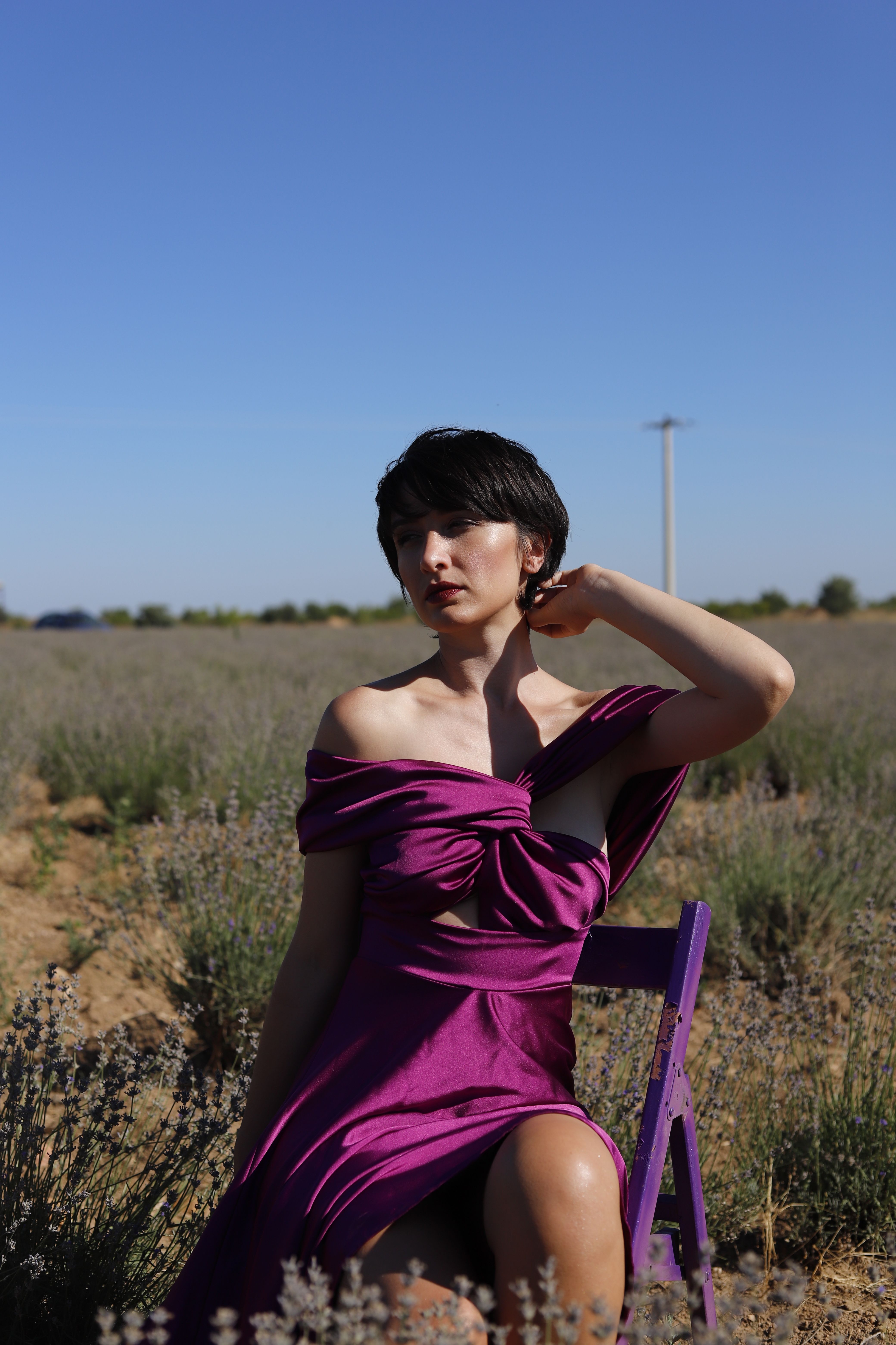 Woman in Purple Dress Sitting on a Folding Chair · Free Stock Photo