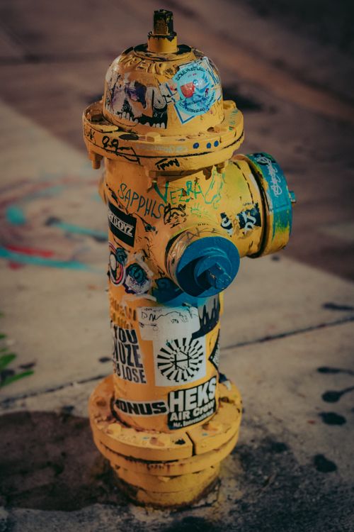 Hydrant Sticker Yellow Fire Hydrant with Stickers · Free Stock Photo