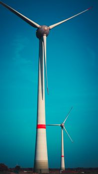 Wind turbines generating renewable energy at a wind farm in Aurich, Germany.
