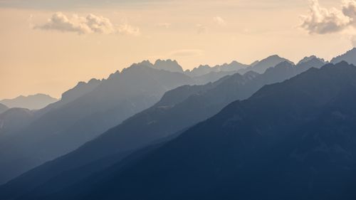 Free A tranquil view of layered mountains with fog at high altitude during the day. Stock Photo