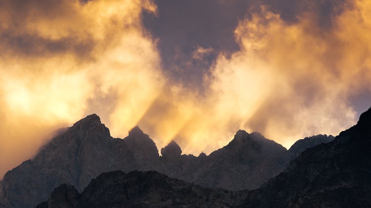 Sun Rays Behind The Rock Mountain