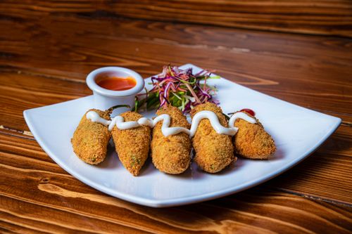 Free Crispy breaded jalapeño peppers served with a tangy dipping sauce for a flavorful appetizer. Stock Photo
