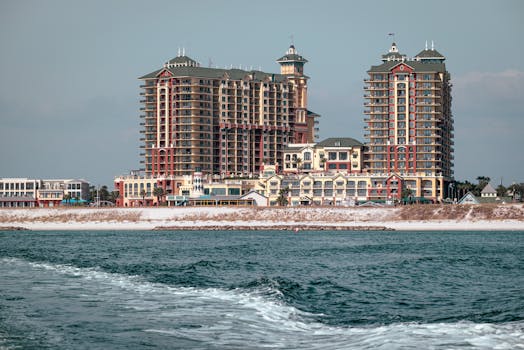 Elegant waterfront buildings overlooking a serene coastal view, perfect for real estate opportunities.