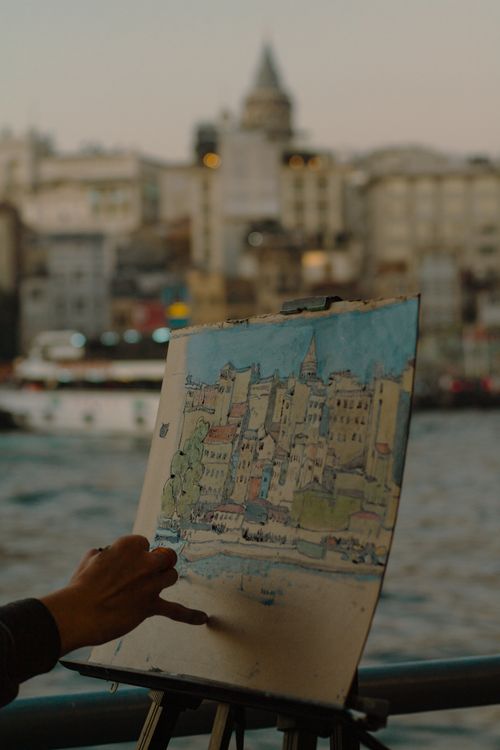 Free A captivating hand-painted view of Galata Tower in Istanbul, framed by a sunset over the Bosphorus. Stock Photo