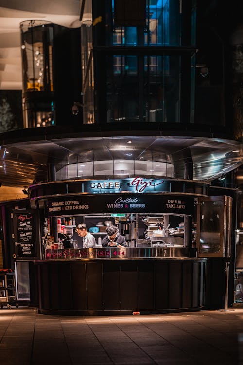 Waiters Working at an Outside Cafe Bar at Night