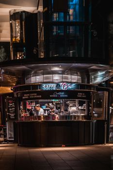 A bustling café in Sydney, Australia at night, capturing the lively atmosphere and city life.