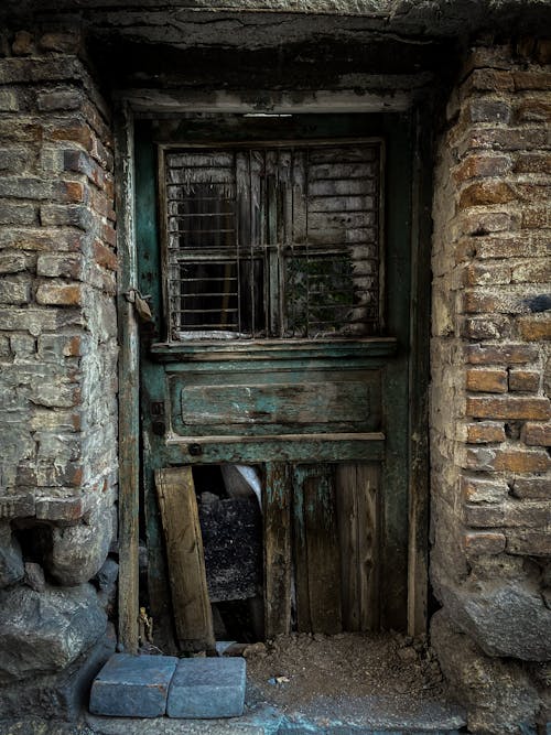 Dilapidated Door on a Brick House