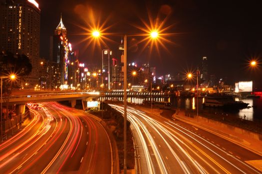 Stunning long exposure night view of a bustling urban expressway with light trails.