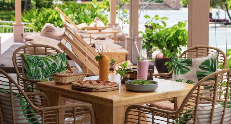 Delicious Pizza And A Couple Of Refreshments On A Wooden Table