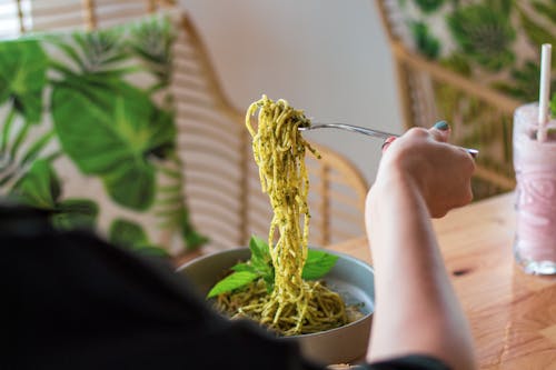 Person Holding Silver Fork With Pasta